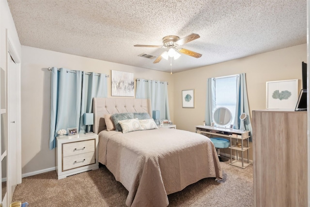 bedroom featuring carpet, a textured ceiling, and ceiling fan