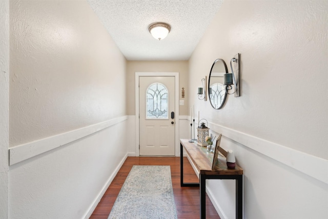 entryway featuring a textured ceiling and dark wood-type flooring