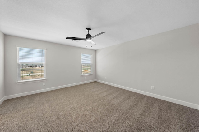 carpeted spare room with ceiling fan