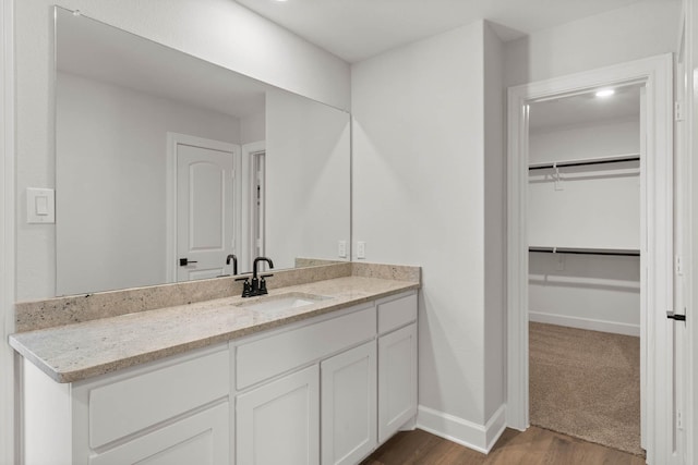 bathroom featuring vanity and hardwood / wood-style flooring