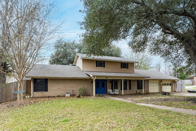 view of property with a garage and a front lawn