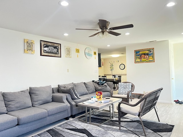 living room with ceiling fan and light wood-type flooring