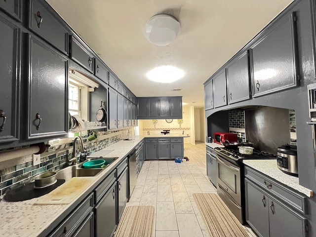 kitchen featuring backsplash, sink, and stainless steel appliances