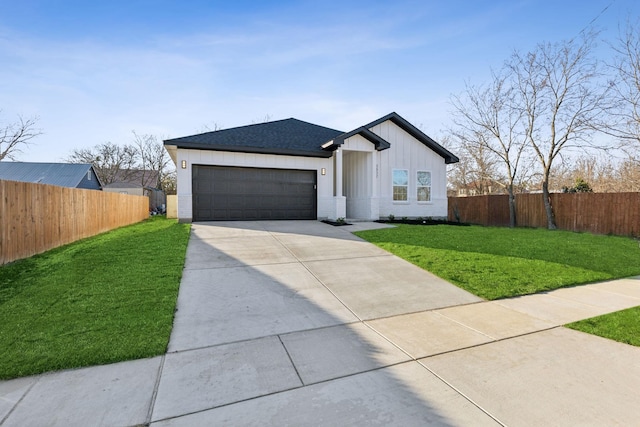 view of front facade with a front yard and a garage