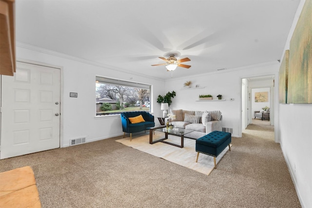 carpeted living room featuring crown molding and ceiling fan