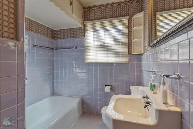 bathroom with tile patterned floors, a tub, sink, and tile walls