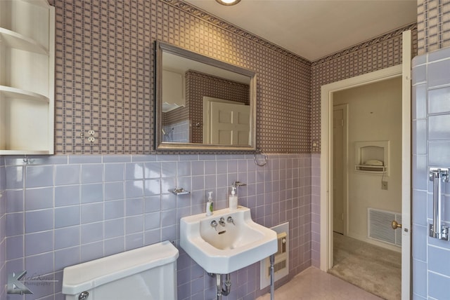 bathroom featuring sink, tile patterned flooring, tile walls, and toilet