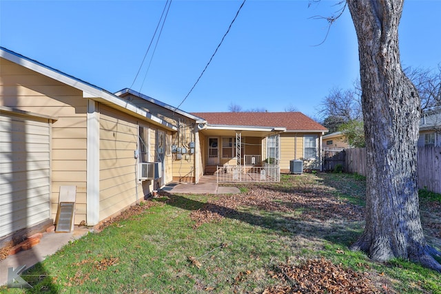 back of house with a patio, a lawn, cooling unit, and central air condition unit