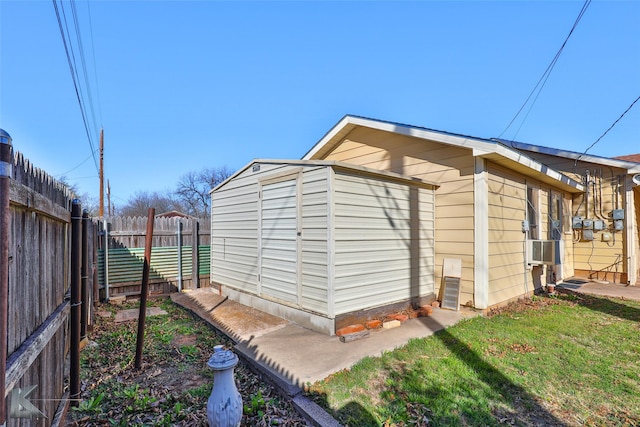 view of outdoor structure with a yard and cooling unit