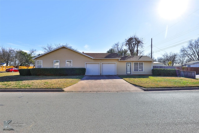 ranch-style house featuring a front yard and a garage