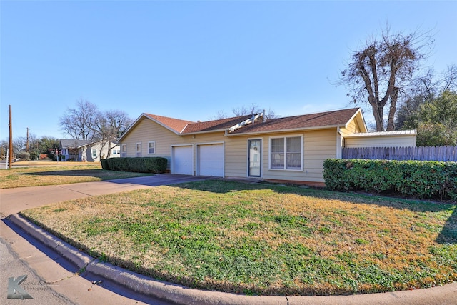 ranch-style home featuring a front lawn and a garage