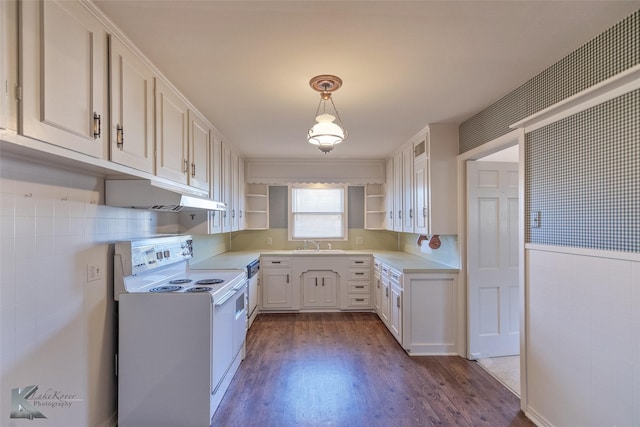 kitchen featuring pendant lighting, sink, white electric range oven, dark hardwood / wood-style flooring, and white cabinetry