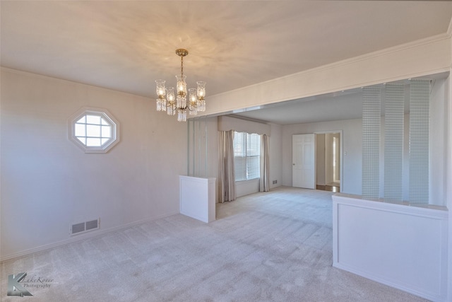 carpeted empty room with crown molding, a wealth of natural light, and an inviting chandelier