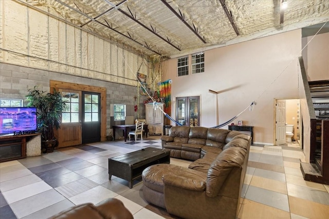 living room featuring french doors and a towering ceiling