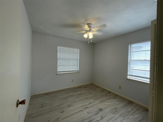 spare room featuring ceiling fan and light wood-type flooring