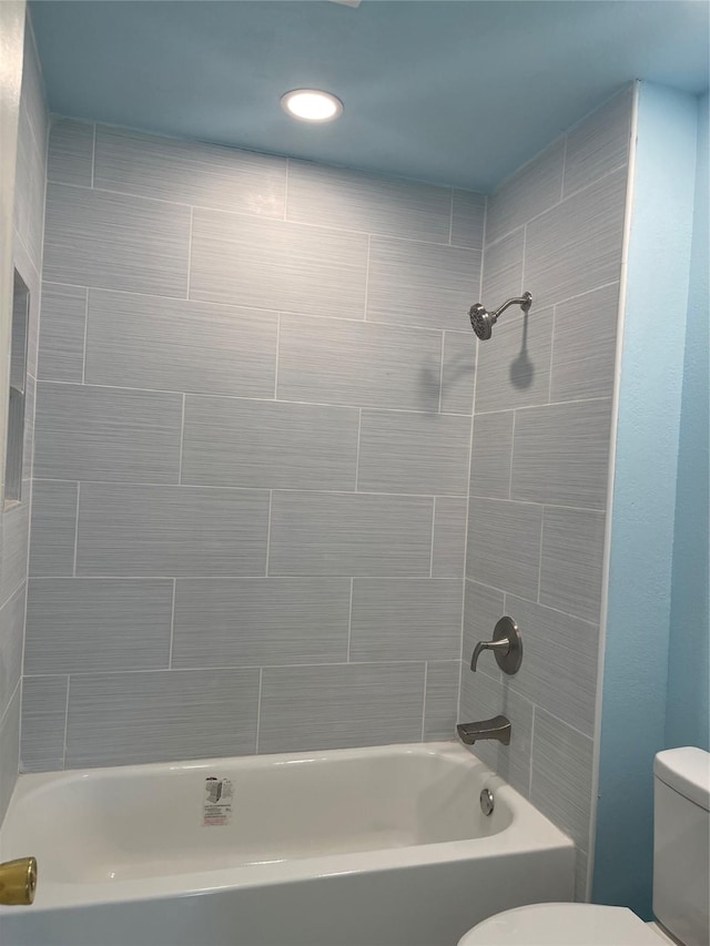 bathroom featuring shower / bathtub combination and toilet