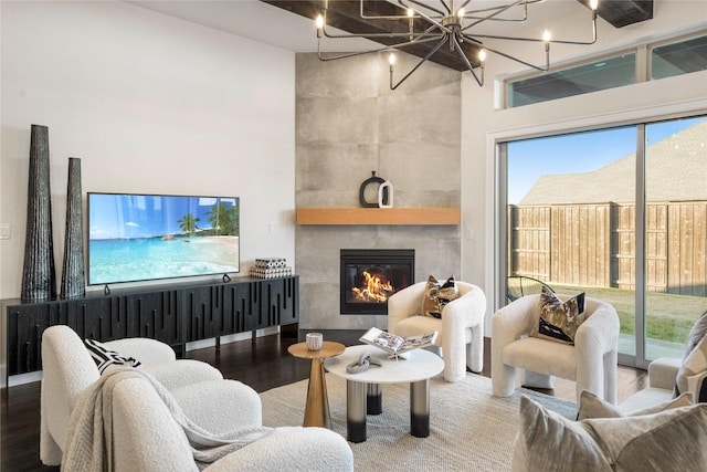 living room featuring a tile fireplace and wood-type flooring