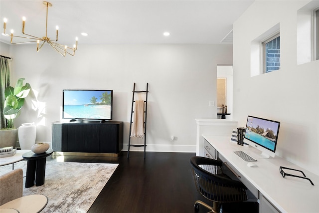 office with an inviting chandelier, built in desk, and dark hardwood / wood-style floors