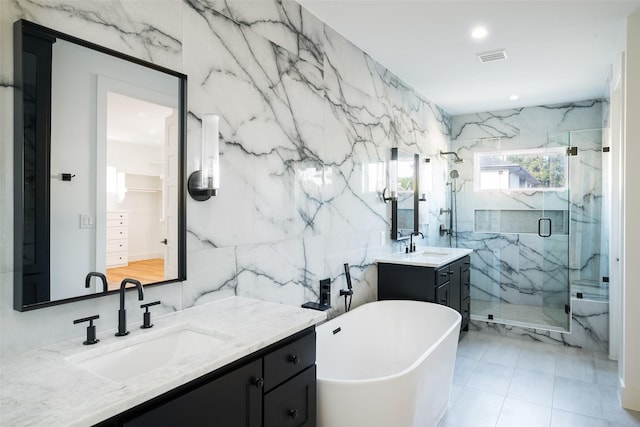 bathroom featuring vanity, separate shower and tub, and tile walls