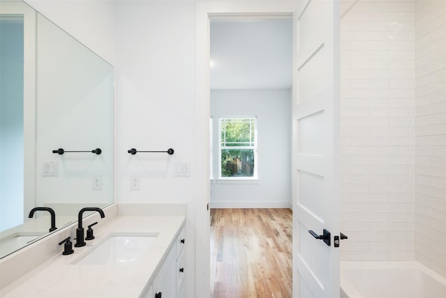 bathroom with vanity, wood-type flooring, and shower / bathtub combination