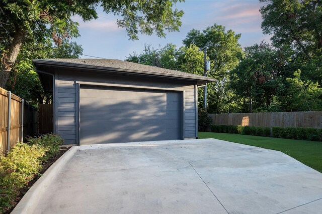 garage at dusk with a yard