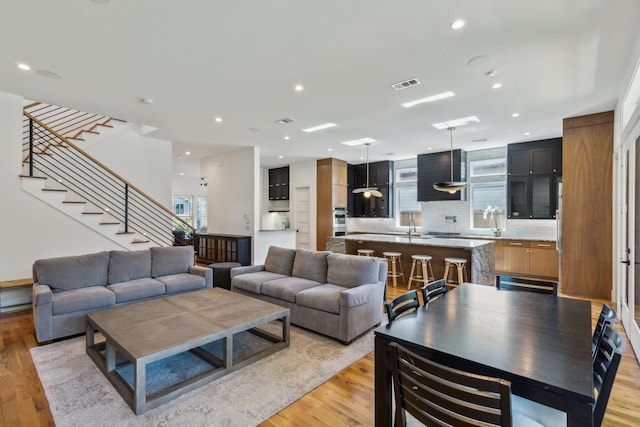 living room featuring light hardwood / wood-style floors and sink