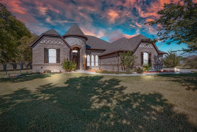 french country inspired facade with a lawn