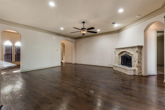 unfurnished living room featuring dark hardwood / wood-style floors, ceiling fan, ornamental molding, and a fireplace