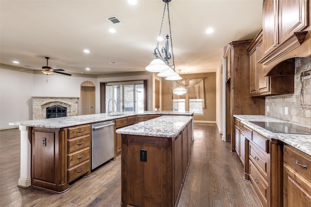 kitchen featuring stainless steel dishwasher, decorative backsplash, ceiling fan, decorative light fixtures, and a kitchen island