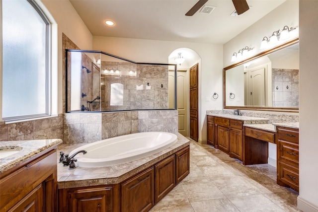 bathroom with ceiling fan, vanity, and shower with separate bathtub