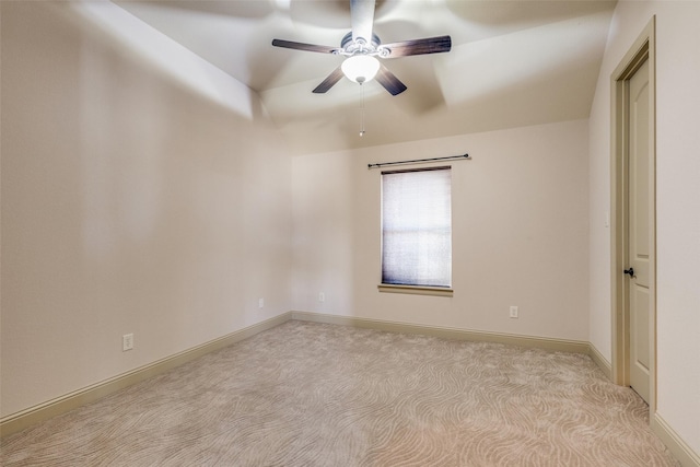 spare room featuring light colored carpet and ceiling fan