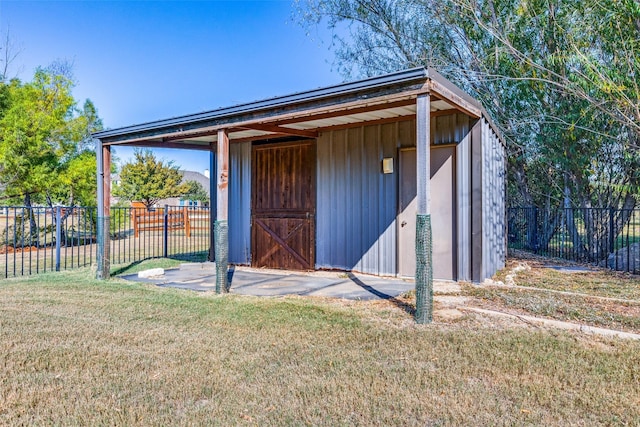 view of outbuilding with a lawn