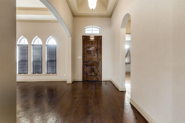 entryway featuring crown molding and dark hardwood / wood-style flooring