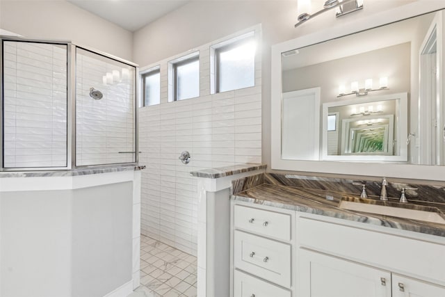 bathroom with vanity and tiled shower