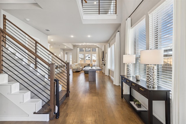 entryway with a notable chandelier and dark wood-type flooring