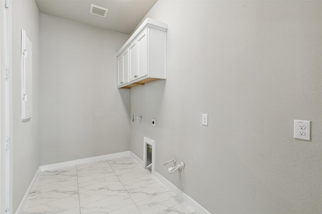 clothes washing area featuring electric dryer hookup, gas dryer hookup, cabinets, and washer hookup