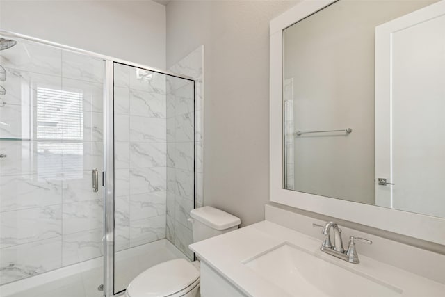 bathroom featuring vanity, an enclosed shower, and toilet