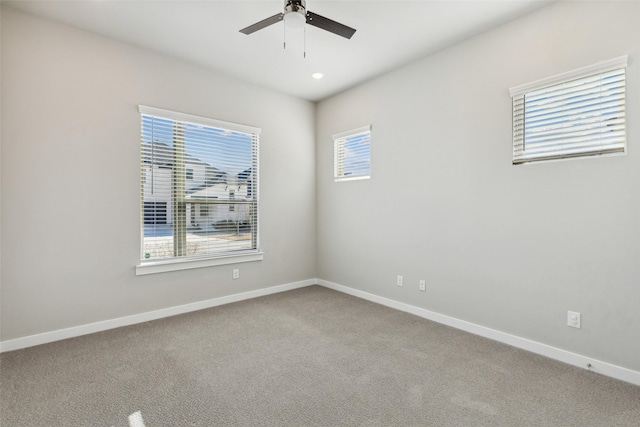 spare room featuring carpet flooring and ceiling fan