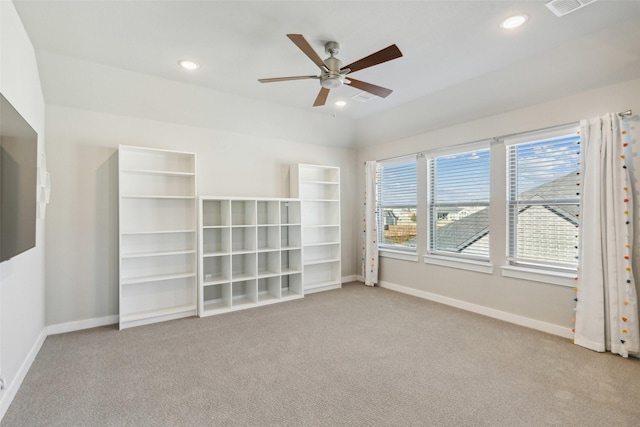 carpeted empty room with ceiling fan and vaulted ceiling