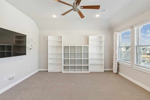 interior space featuring carpet floors, vaulted ceiling, and ceiling fan