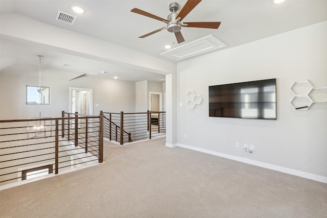 unfurnished room with light colored carpet and ceiling fan