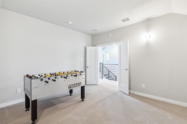 rec room featuring light colored carpet and vaulted ceiling