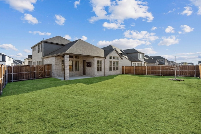 back of house featuring a patio area and a lawn