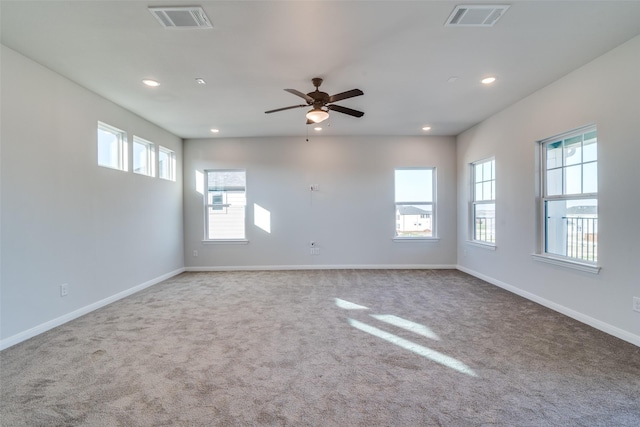 carpeted spare room with ceiling fan