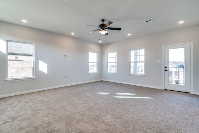 empty room with ceiling fan and light colored carpet