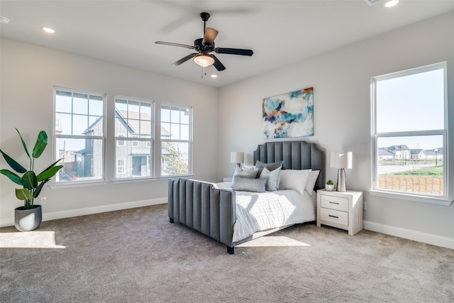 bedroom with ceiling fan and light carpet