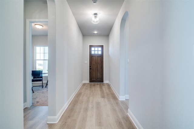 doorway with light wood-type flooring