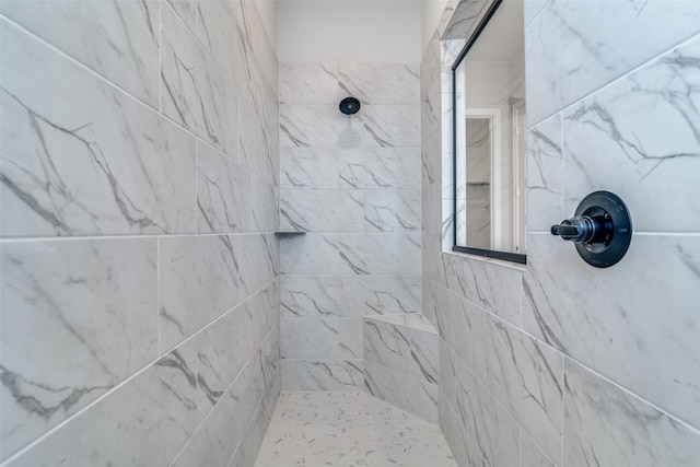 bathroom with tiled shower