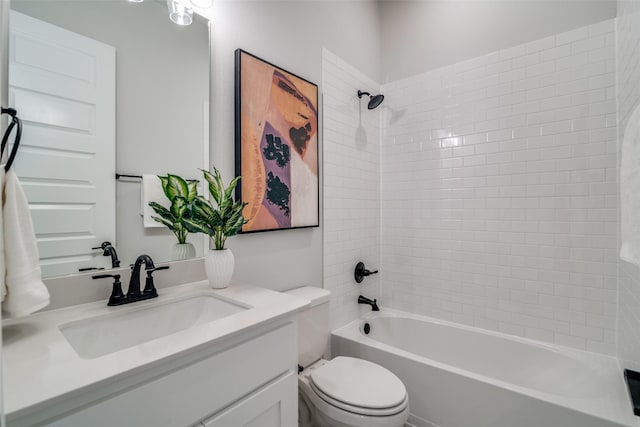 full bathroom with vanity, toilet, and tiled shower / bath