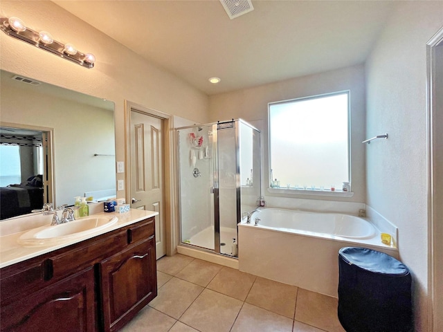 bathroom featuring plenty of natural light, tile patterned flooring, independent shower and bath, and vanity